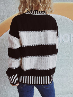 Black and white striped mock neck sweater with textured knit details.