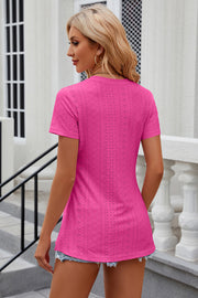 Hot Pink perforated crewneck top with side slits and short sleeves.