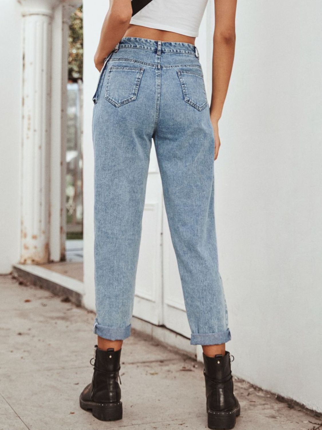 Light wash barrel leg jeans with pocket detail and cuffed hems.