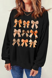 Black crewneck sweatshirt with a grid of autumn-themed bow prints.