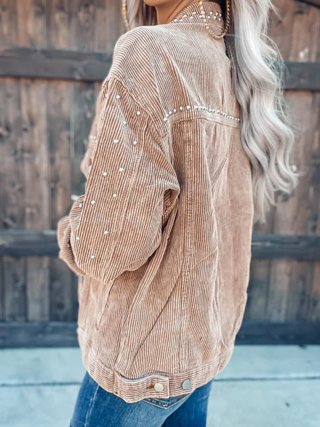 Tan corduroy jacket with pearl studs on collar, shoulders, and sleeves.