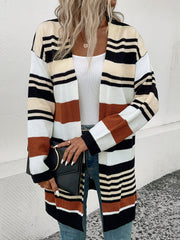Bold stripe knit duster cardigan with burnt orange, black, white, and cream stripes.