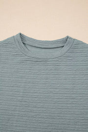 Textured crew neck t-shirt in air force blue with cap sleeves and a casual fit.