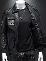 Black leather bomber jacket with patches and chest pockets, open front showing black shirt and necklace.