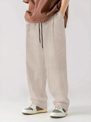 Textured corduroy relaxed fit trousers in white with drawstring waist.