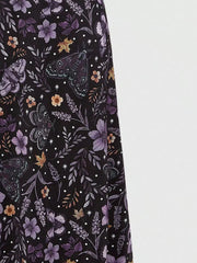 Black midi skirt with a whimsical floral and butterfly print.