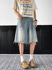 Light-wash distressed denim shorts with raw hem and ripped details.
