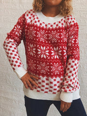 Red and white snowflake knit sweater with crew neck and ribbed cuffs and hem.