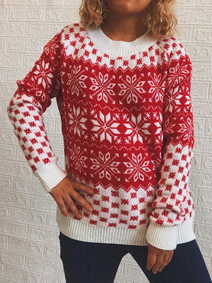 Red and white snowflake knit sweater with crew neck and ribbed cuffs and hem.