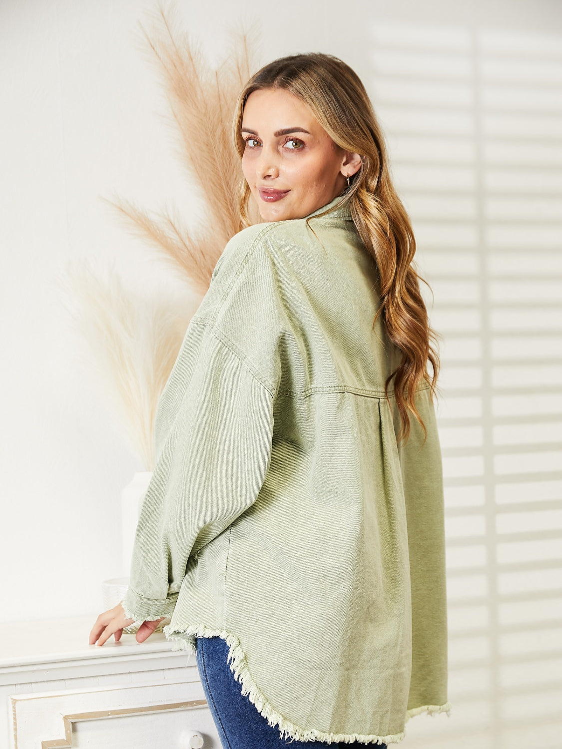 Light Green distressed denim overshirt with raw hem and buttoned front.