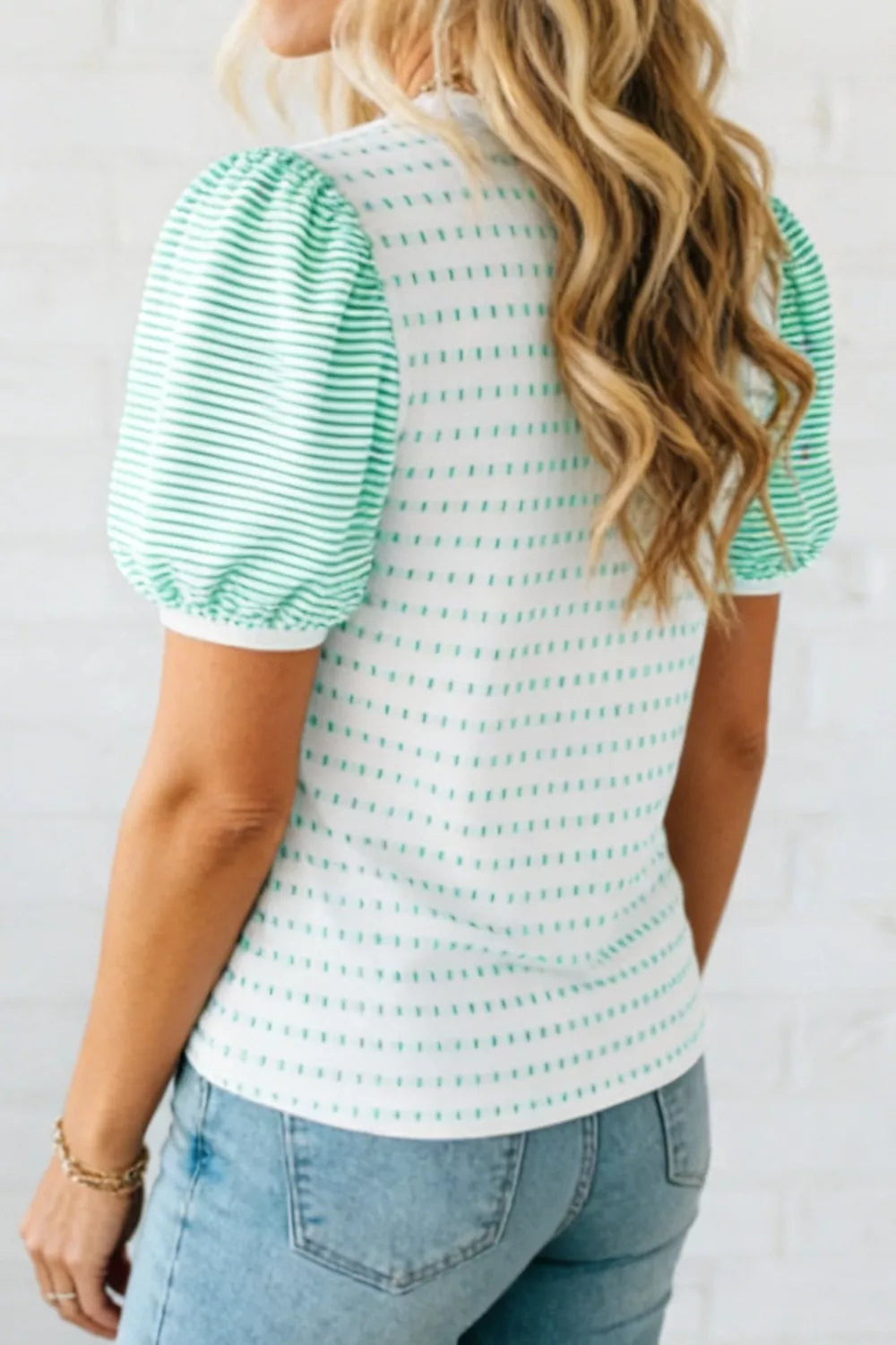 White t-shirt with green dash print and striped puff sleeves.