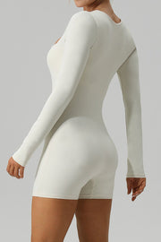Sculpted square neck ivory long sleeve unitard with short legs.