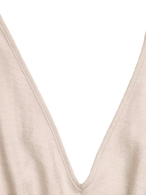 Beige V-neck romper with ruffled detail and wide legs