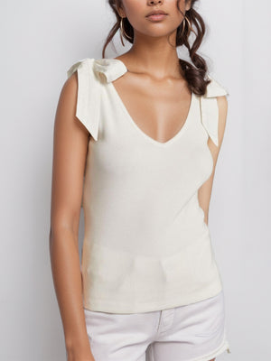 Ribbed knit tank top in white with V-neck and bow shoulder details.