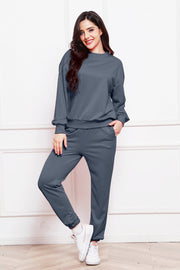Relaxed fit dark gray loungewear set with crewneck sweatshirt and cuffed sweatpants.