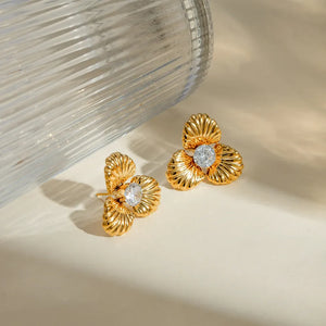 Gold petal stud earrings with clear crystal accents