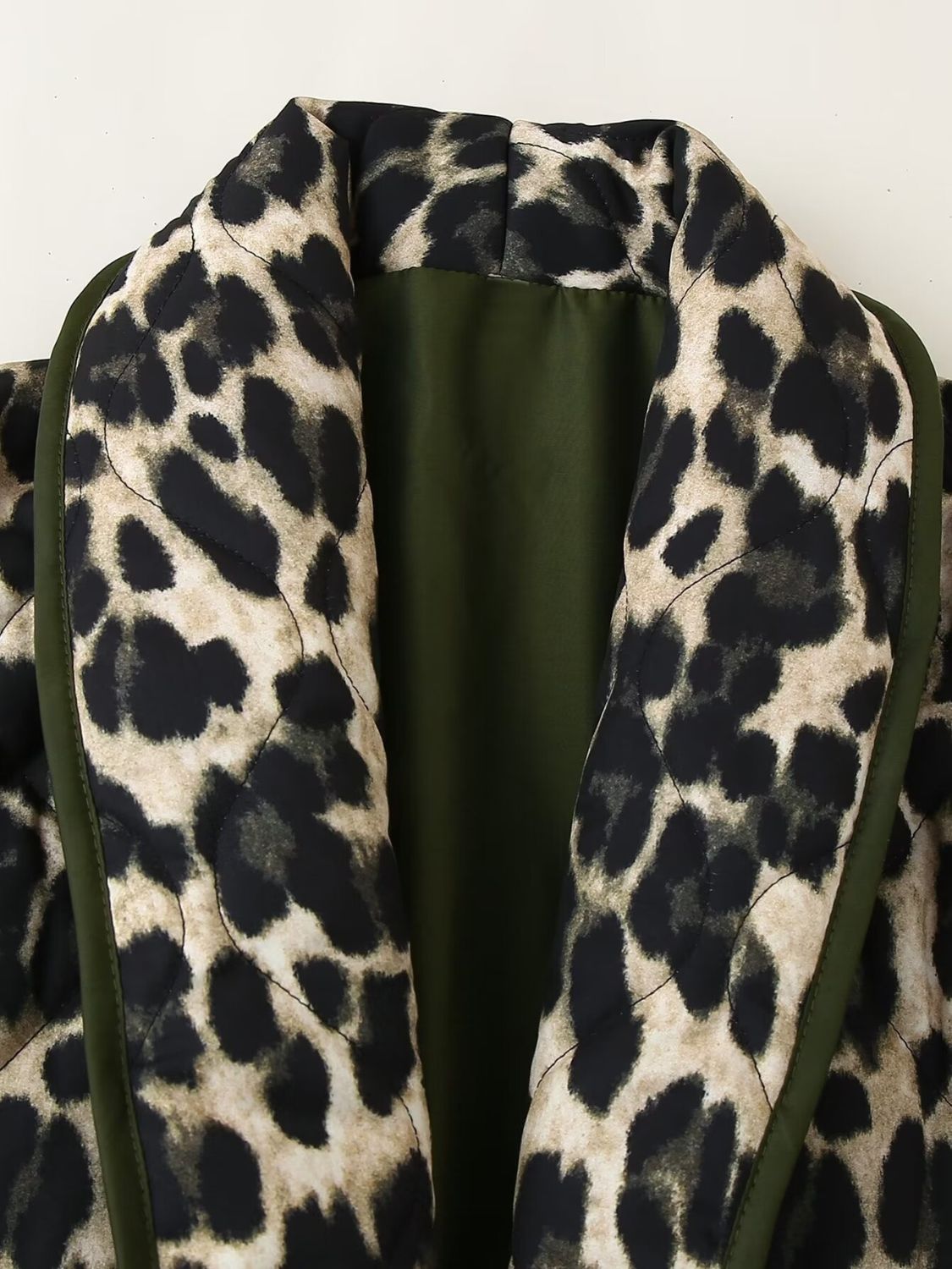 Leopard quilted kimono jacket with green lining and trim, open front detail.