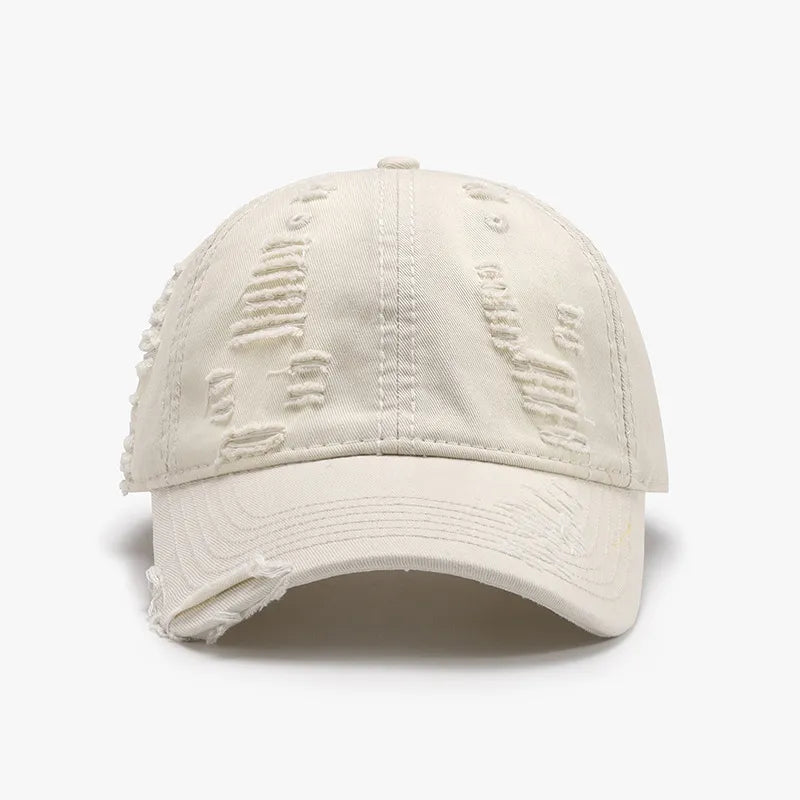 Distressed canvas baseball cap in Ivory with ripped details and frayed brim.