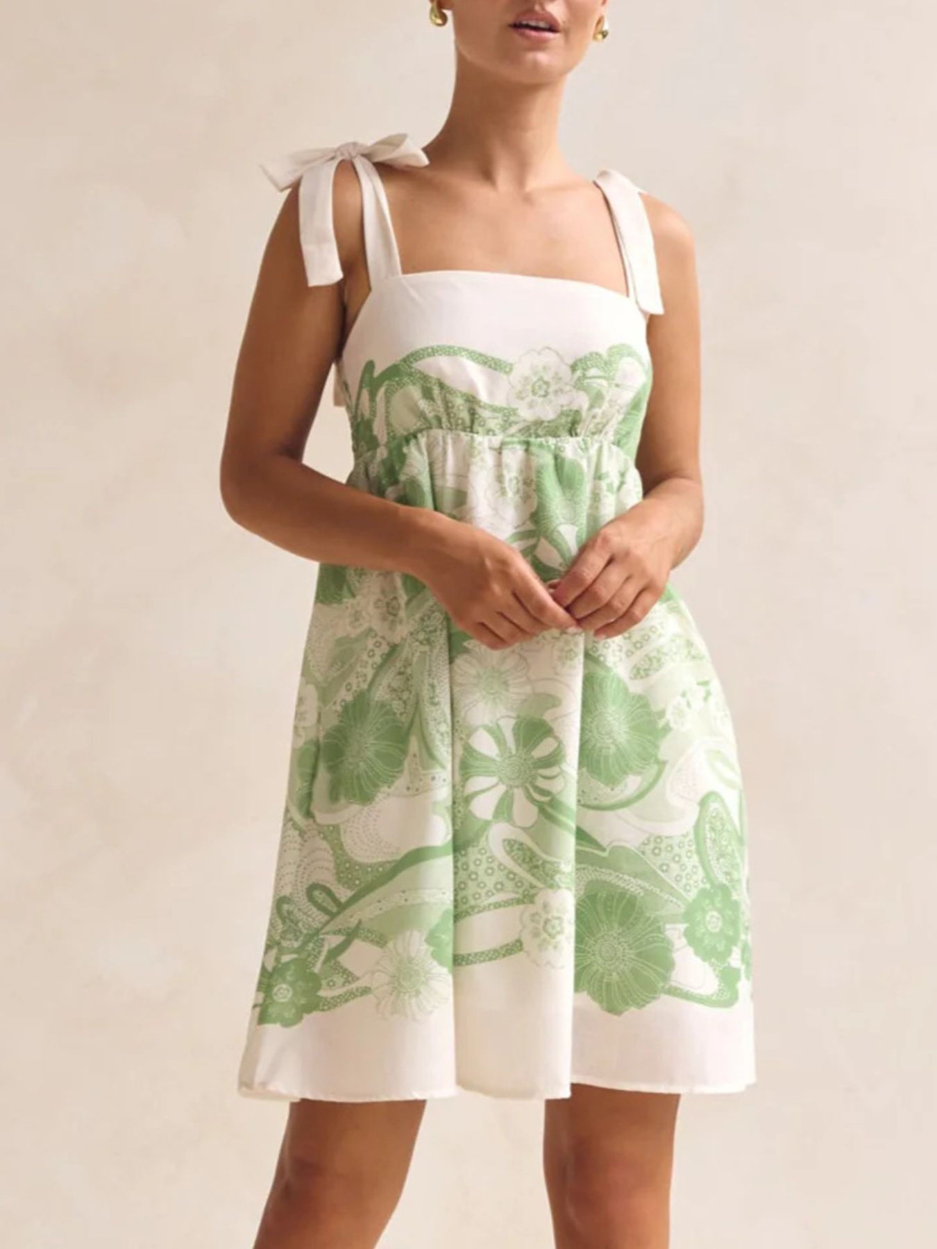 Green floral tie-strap mini dress with square neckline and pockets