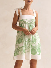 Green floral tie-strap mini dress with square neckline and pockets