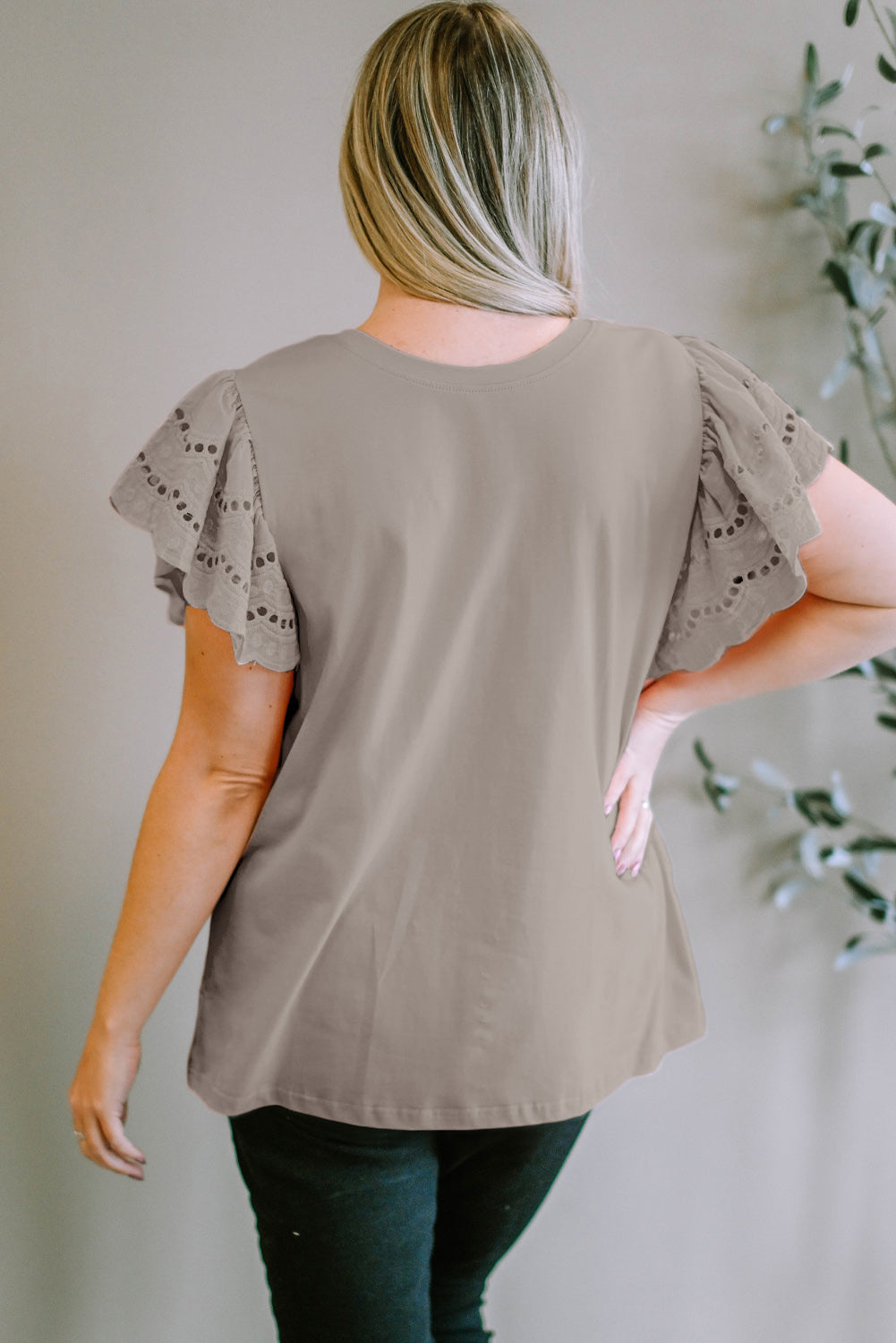 Mocha eyelet flutter sleeve tee with a round neckline.