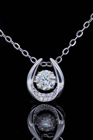 Silver orbital diamond halo necklace with a central stone and pave accents.