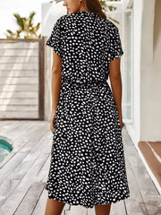Black and white animal print midi dress with tied waist and short sleeves.