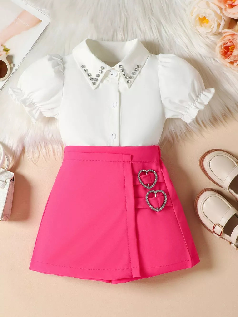 Toddler white puff sleeve shirt with rhinestone collar and pink A-line skirt with heart buckles