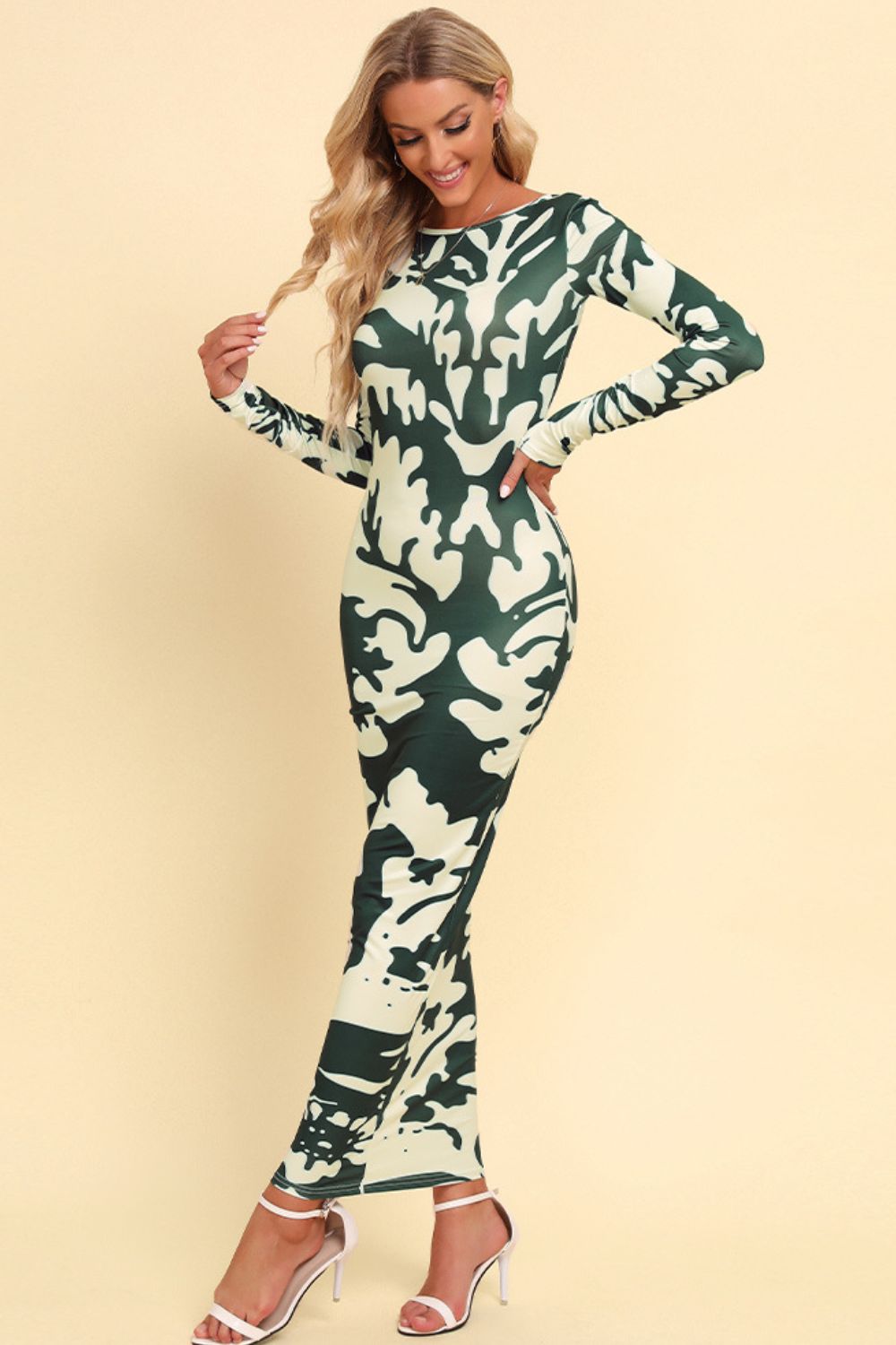 Green camouflage backless maxi dress with long sleeves and a bold abstract pattern.