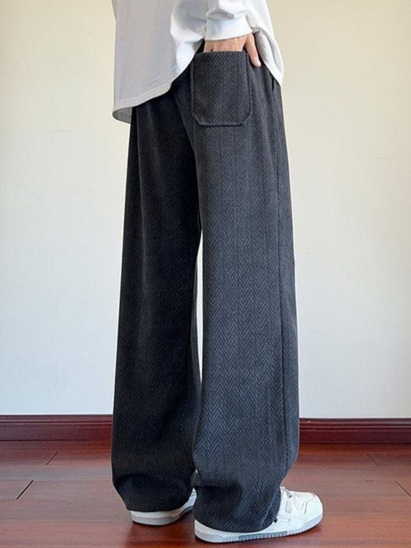 Men's gray textured wide leg sweatpants with a herringbone pattern and a back pocket.