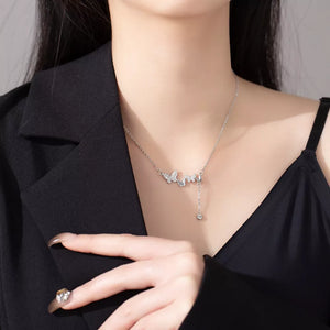 Delicate silver necklace with butterfly charms and zircon accents, featuring a dangling charm.