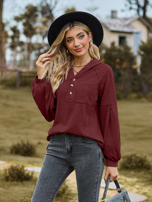 Textured knit henley in wine with balloon sleeves and buttoned placket.