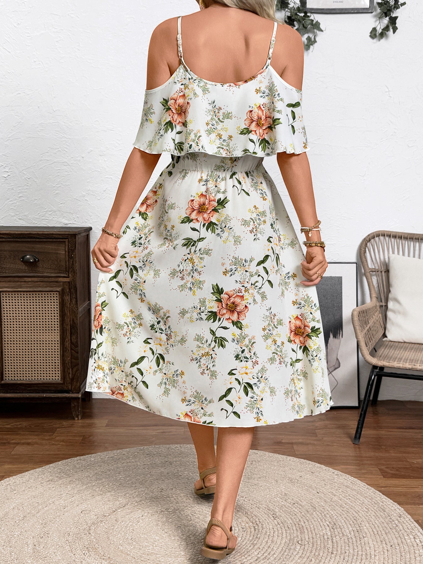 Floral print cold shoulder dress with ruffled neckline and spaghetti straps.
