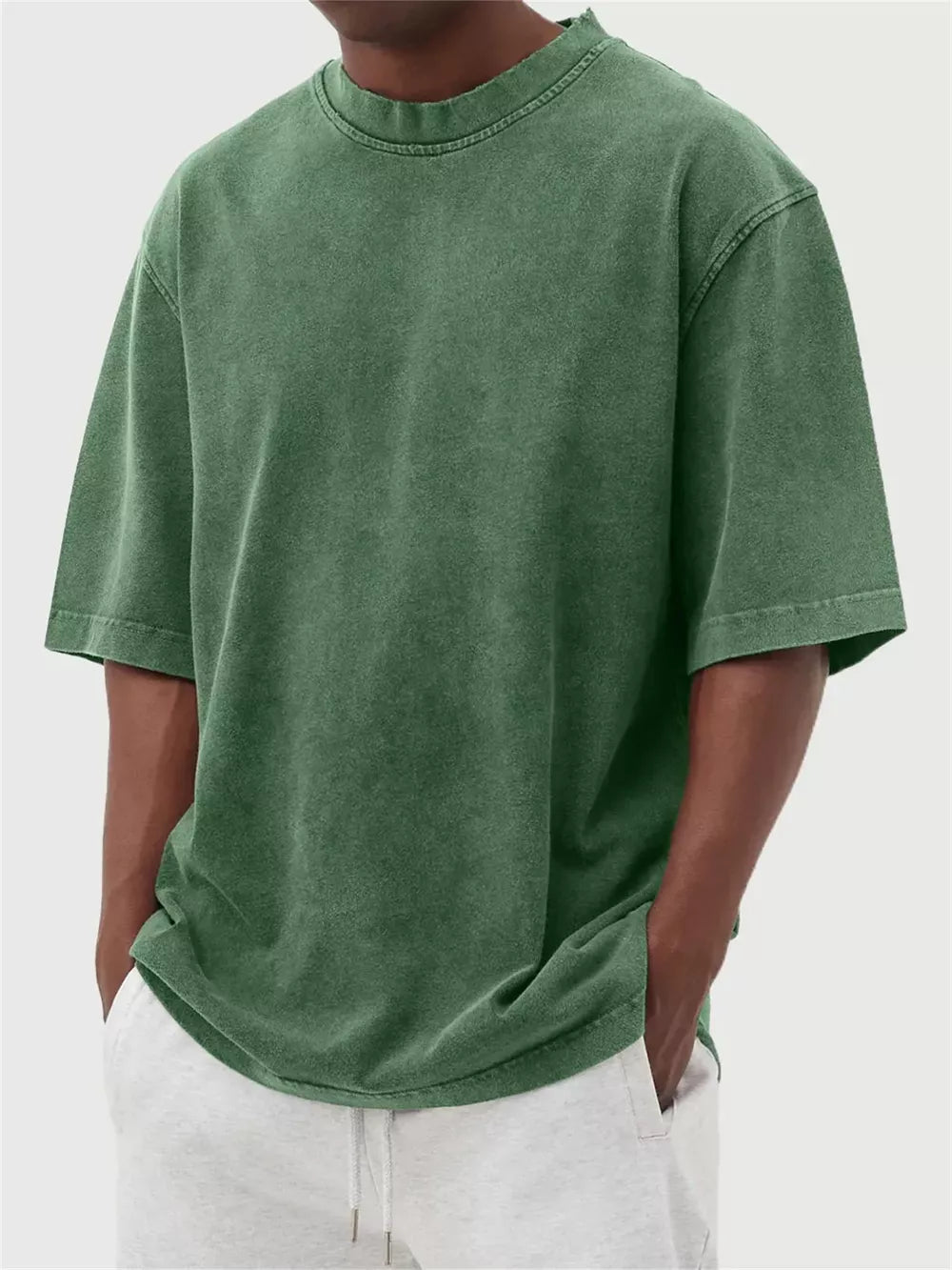 Men's green vintage wash oversized crew neck cotton tee with distressed neckline.