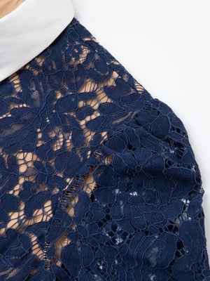 Navy lace midi dress with white collar and puff sleeves detail.