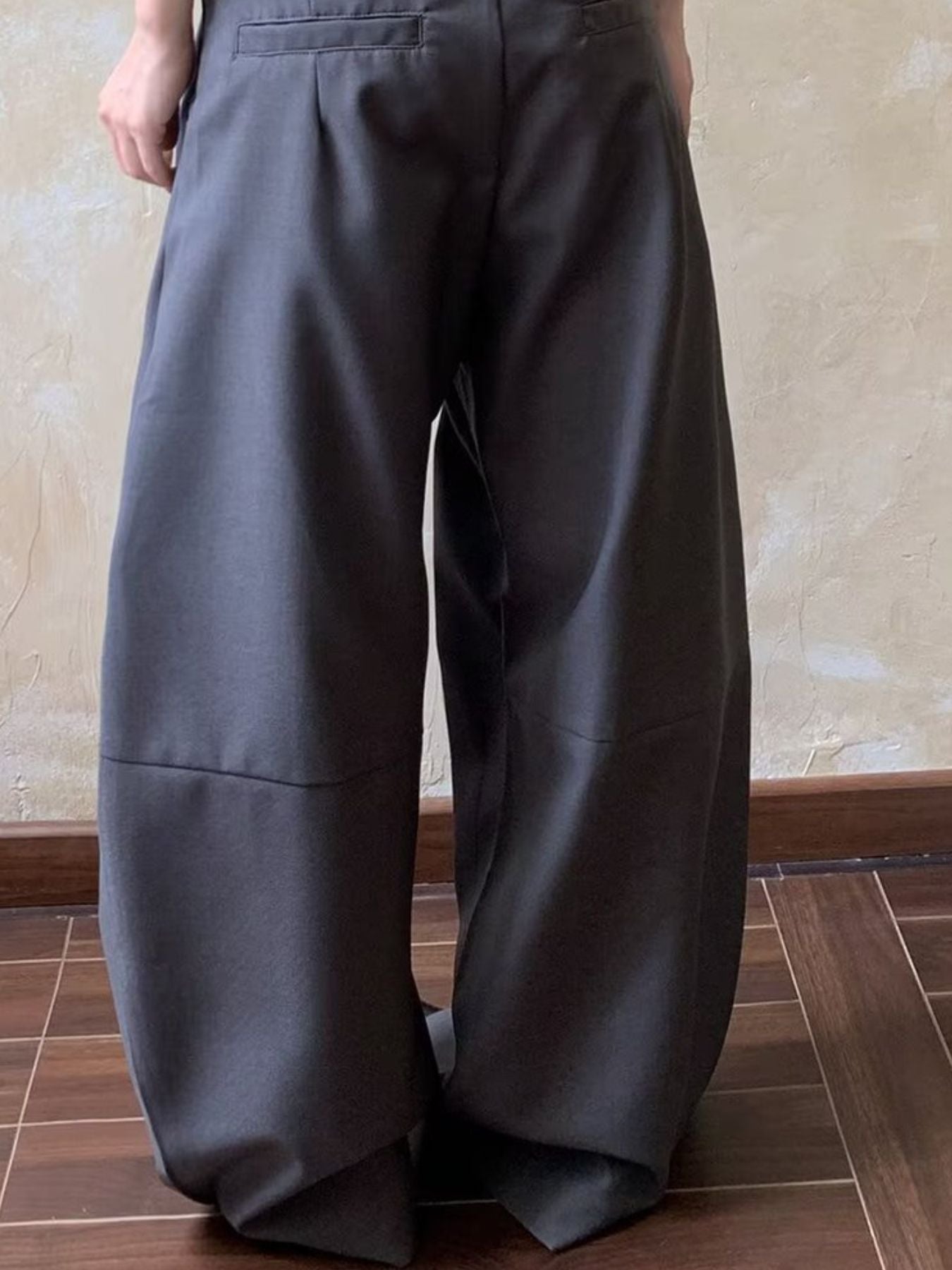 Men's gray wide leg pleated sweatpants with a relaxed fit.