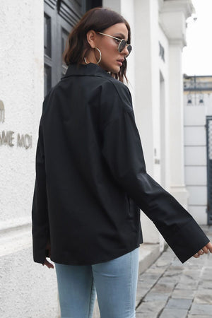 Black oversized cotton poplin shirt with buttoned cuffs and a relaxed fit.