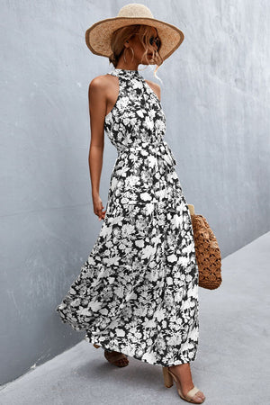 Black and white floral print maxi dress with halter neckline and tie waist.