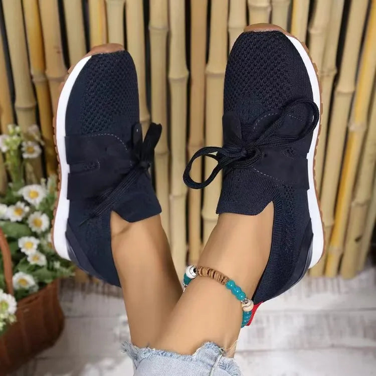 Navy knit & suede lace-up sneakers with white soles and brown accents.