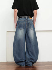 Belted wide leg jeans in dark blue denim with a balloon silhouette.