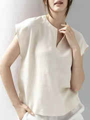 White cap sleeve shirt with notched neckline and relaxed fit.