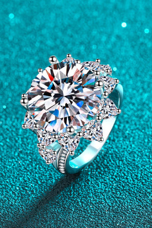 Silver moissanite cocktail ring with a large center stone and surrounding pear-shaped stones.