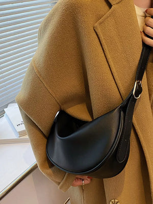 Black minimalist crescent crossbody bag with adjustable strap