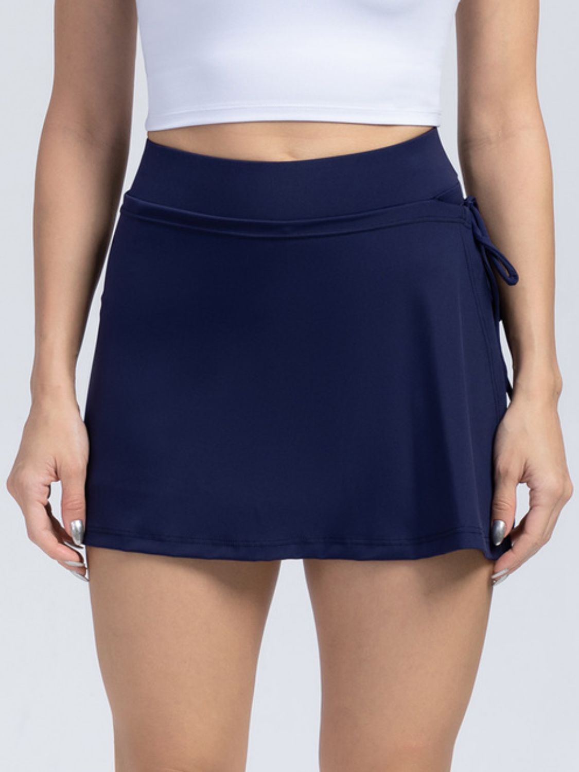 Dark blue wrap-detail skort with side tie and elastic waistband.
