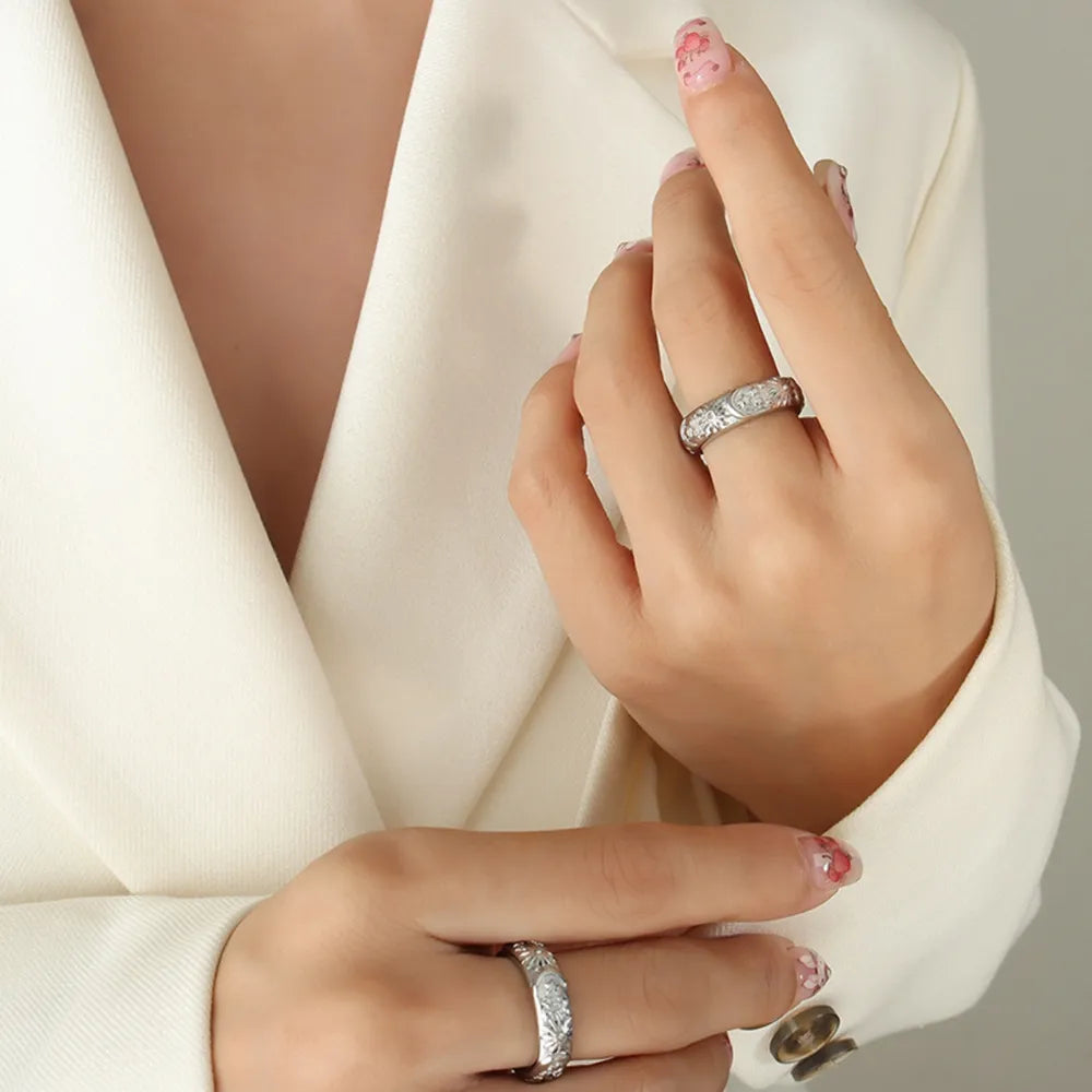 Silver celestial engraved titanium band ring on hand