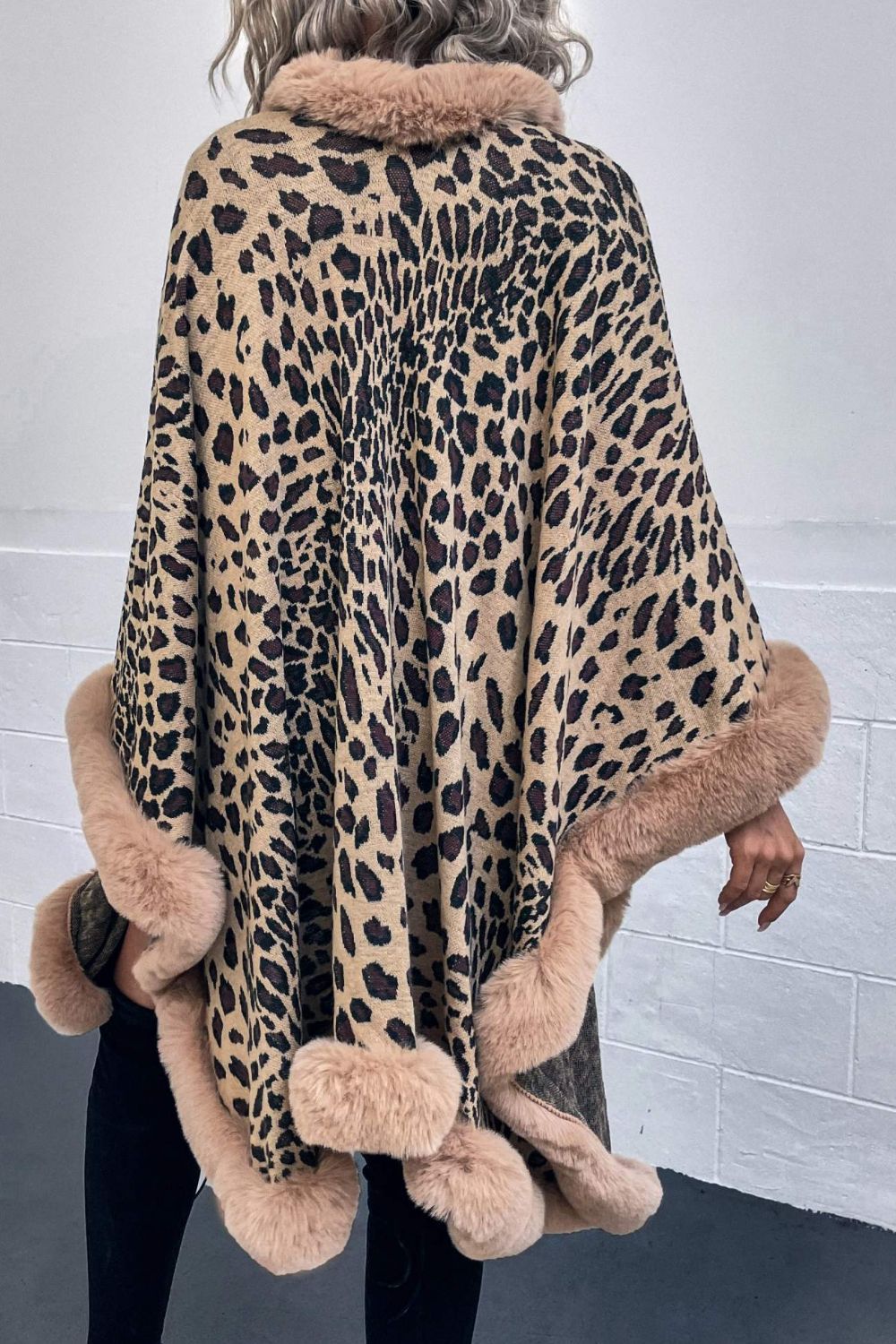Leopard print acrylic cape with faux fur trim in beige, camel, and chocolate colors.