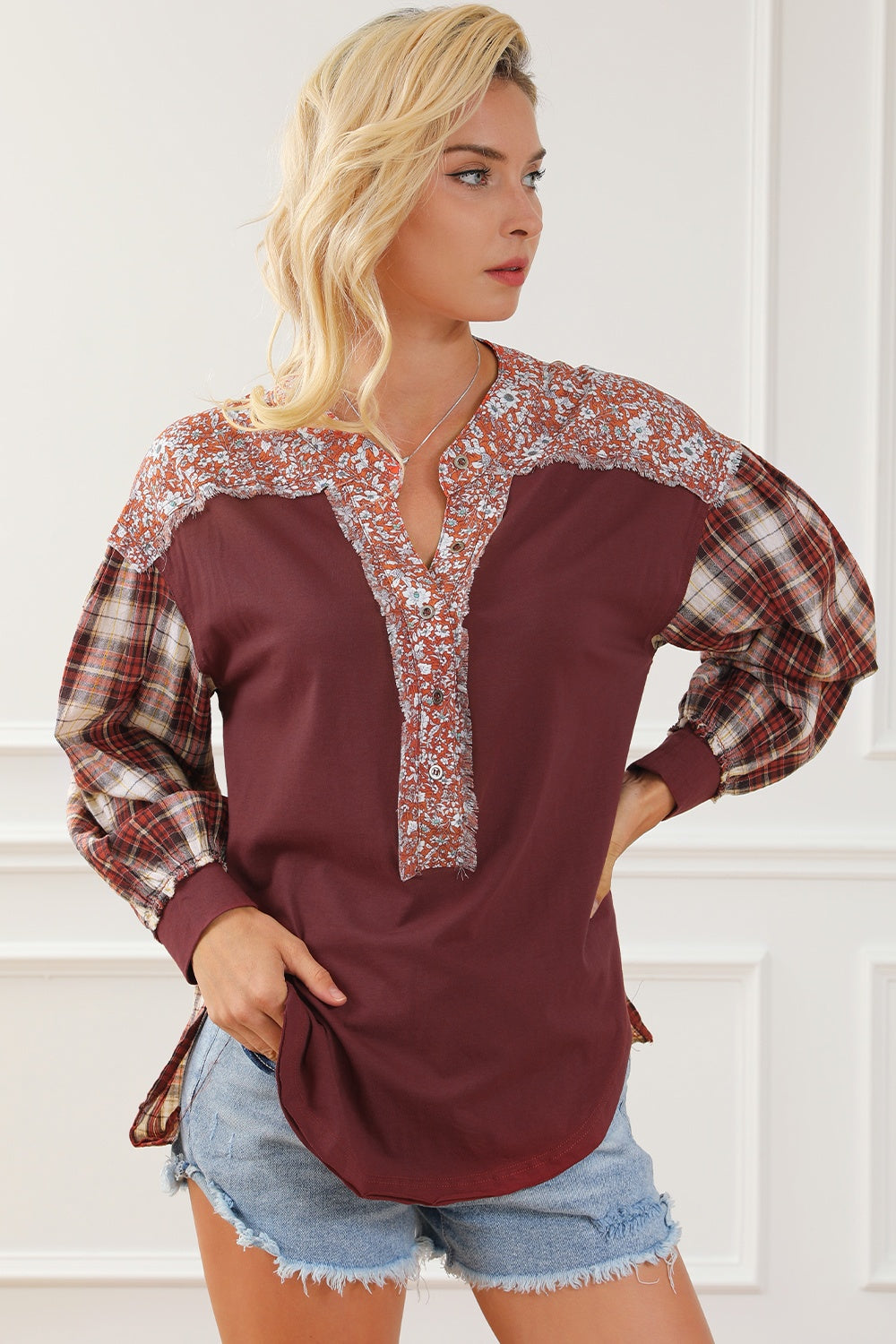 Burgundy mixed media blouse with floral yoke and plaid sleeves.