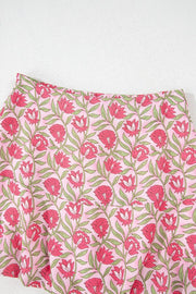 Floral print A-line skirt in dusty pink with pink blooms and green leaves.