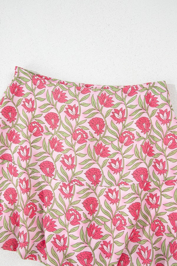 Floral print A-line skirt in dusty pink with pink blooms and green leaves.
