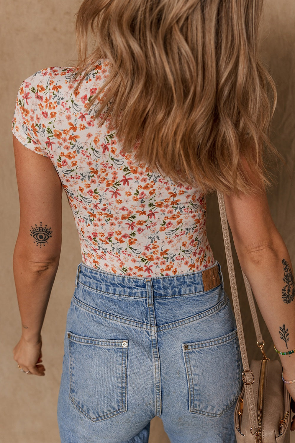 Floral print ruched bodysuit with sweetheart neck and short sleeves.